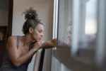 woman looking out window